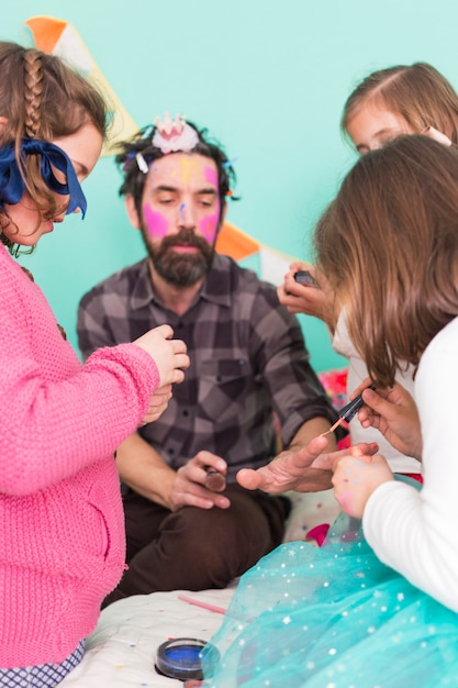 Hombre con hijas teniendo procedimientos de belleza