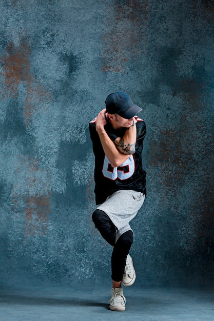 Hombre joven break dance en el fondo de la pared.