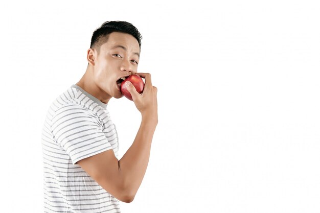 Hombre joven mordiendo manzana