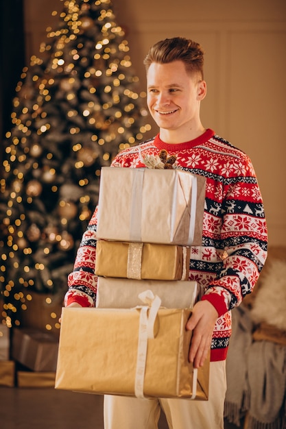 Hombre joven con regalos de Navidad