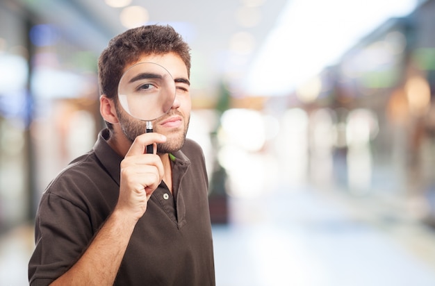 Foto gratuita hombre con una lupa en un centro comercial