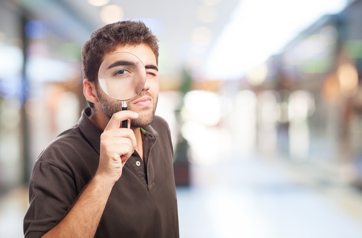 Foto gratuito hombre con una lupa en un centro comercial