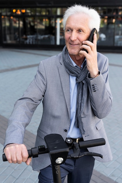Hombre mayor en la ciudad hablando por teléfono inteligente