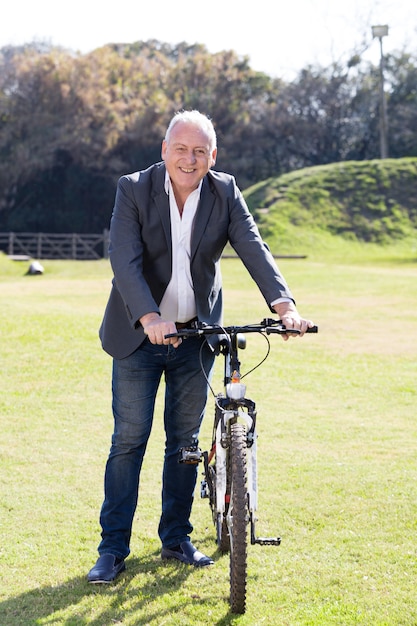 Foto gratuita hombre mayor disfrutando con la bicicleta