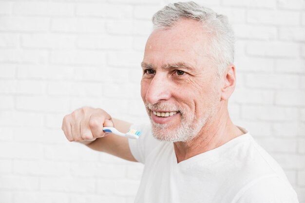 Hombre mayor lavándose los dientes