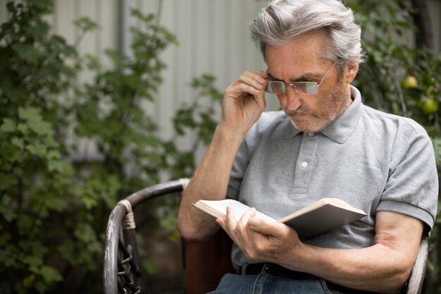 Hombre mayor leyendo su lección para la escuela