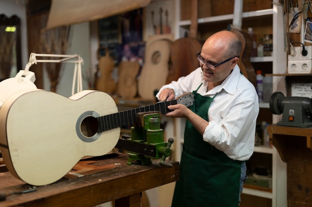 Hombre de mediana edad en su taller de instrumentos