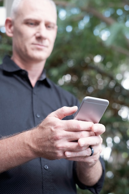 Hombre mensajes de texto en teléfono inteligente