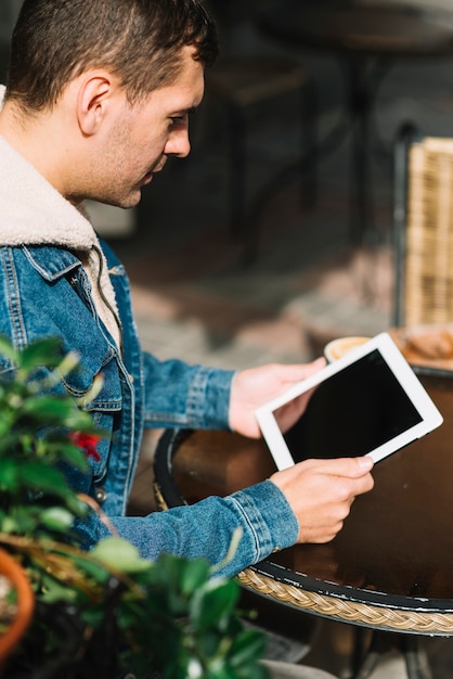 Hombre moderno con tableta en entorno urbano