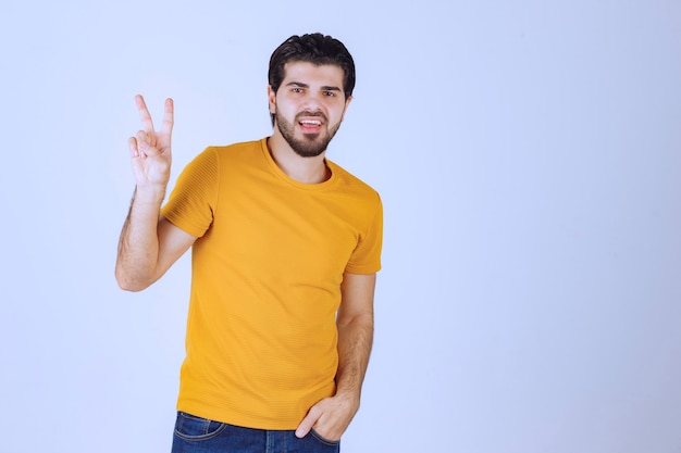 Hombre mostrando signo de paz y amistad en la mano.