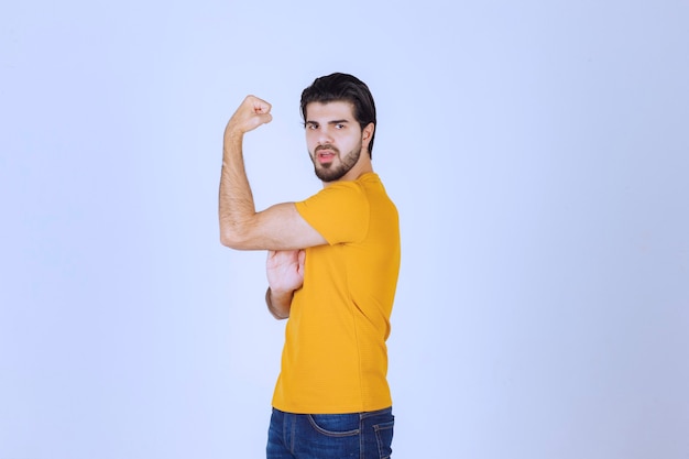 Foto gratuita el hombre muestra los músculos del brazo y se siente poderoso.