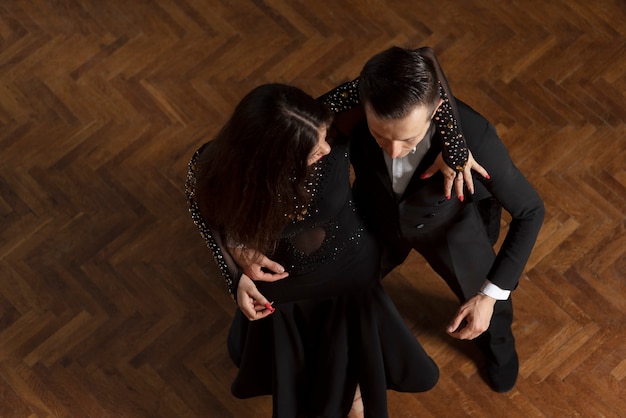 Hombre y mujer bailando juntos en una escena de salón de baile