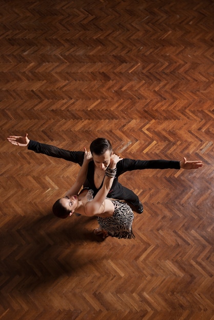 Hombre y mujer bailando juntos en una escena de salón de baile