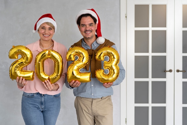 Foto gratuita hombre y mujer celebrando la víspera de año nuevo en casa juntos