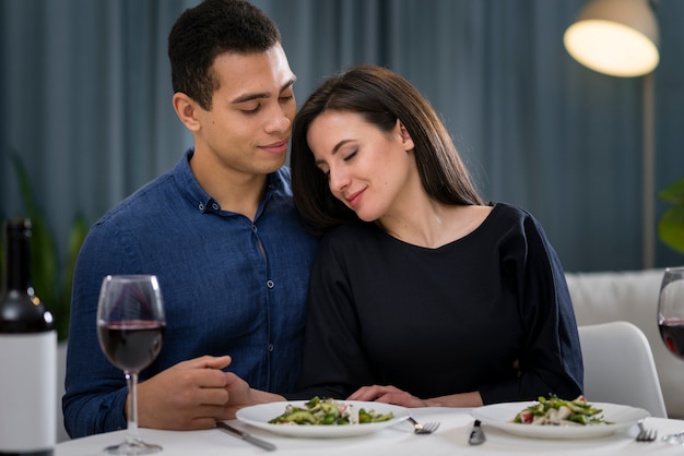 Hombre y mujer estando cerca en su cena romántica