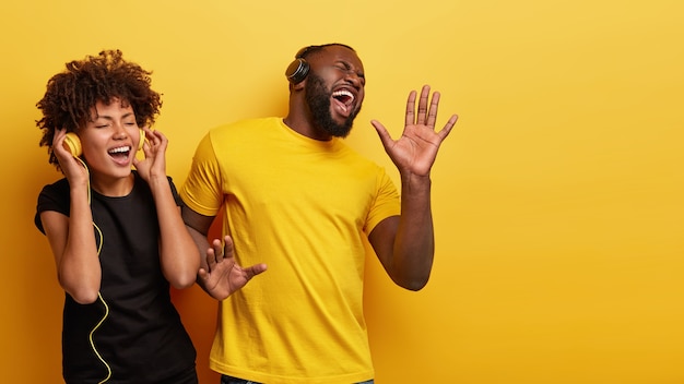 Hombre y mujer joven escuchando música en auriculares
