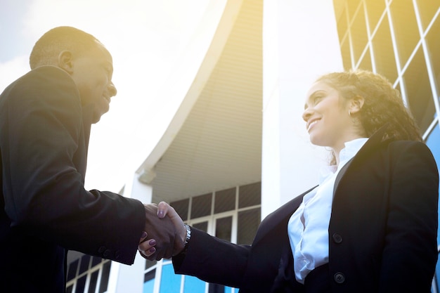 Hombre y mujer de negocios apretando manos