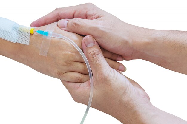 Hombre con mujer, paciente, mano con un tubo de inyección de medicina en una cama en un hospital