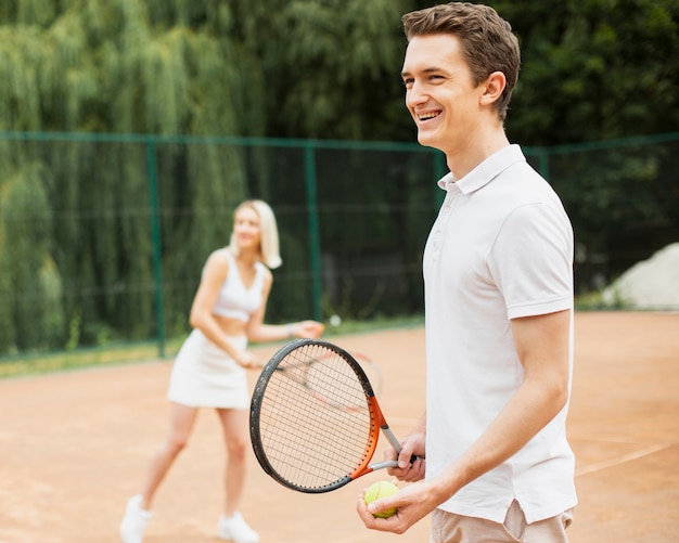 Foto gratuita hombre y mujer practicando tenis