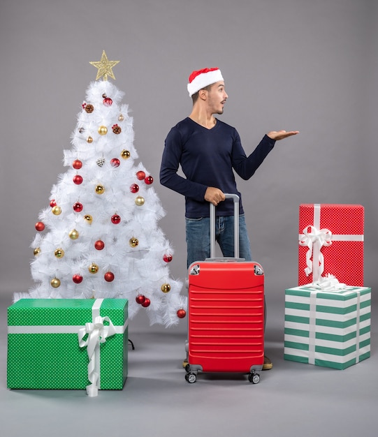 Hombre de Navidad con gorro de Papá Noel que muestra la dirección