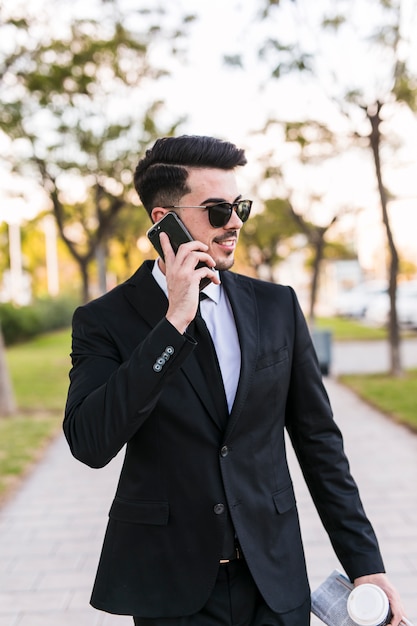 Hombre de negocios hablando por teléfono en el parque