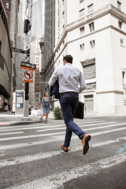 Hombre de negocios irreconocible corriendo en la calle