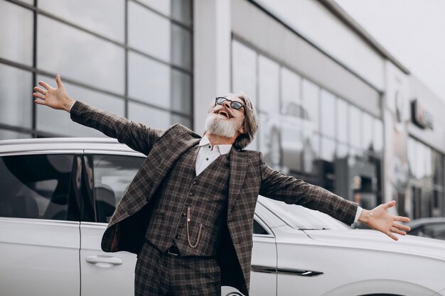 Hombre de negocios de mediana edad en un salón de autos