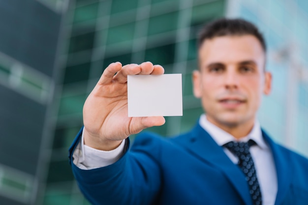 Hombre de negocios presentando tarjeta de visita en blanco