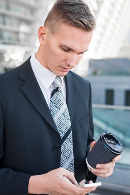 Hombre de negocios sujetando taza de café