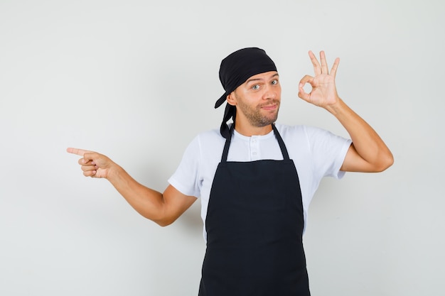 Foto gratuita hombre panadero en camiseta, delantal mostrando gesto ok