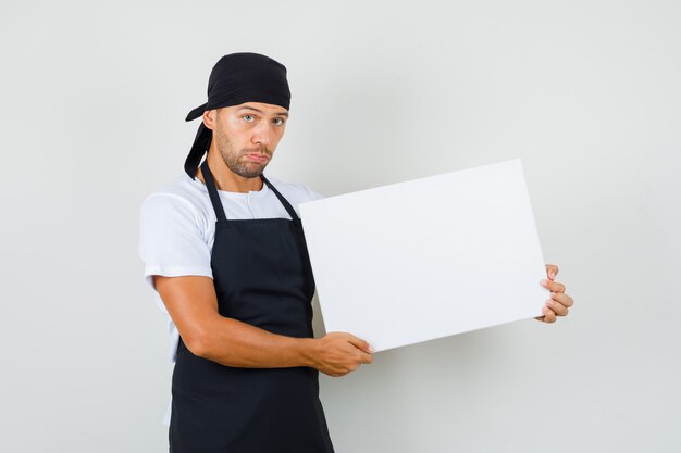 Hombre panadero sosteniendo lienzo vacío en camiseta