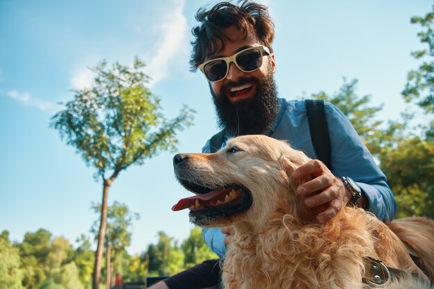 Hombre y perro divirtiéndose, jugando, haciendo muecas