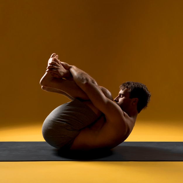 Foto gratuita hombre de pie en pose de cabeza a rodilla