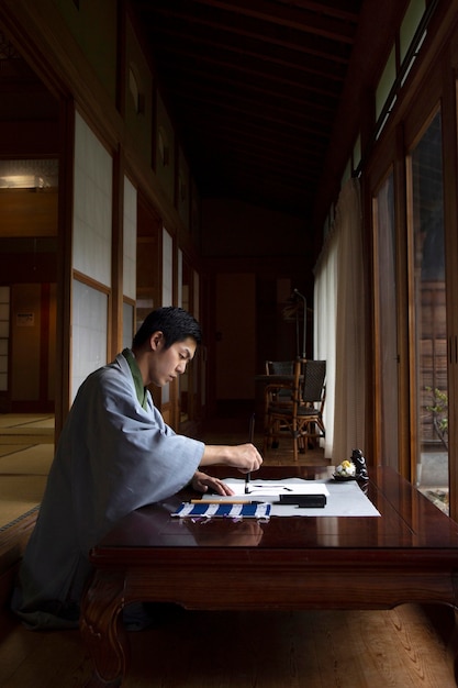 Foto gratuita hombre practicando la escritura japonesa