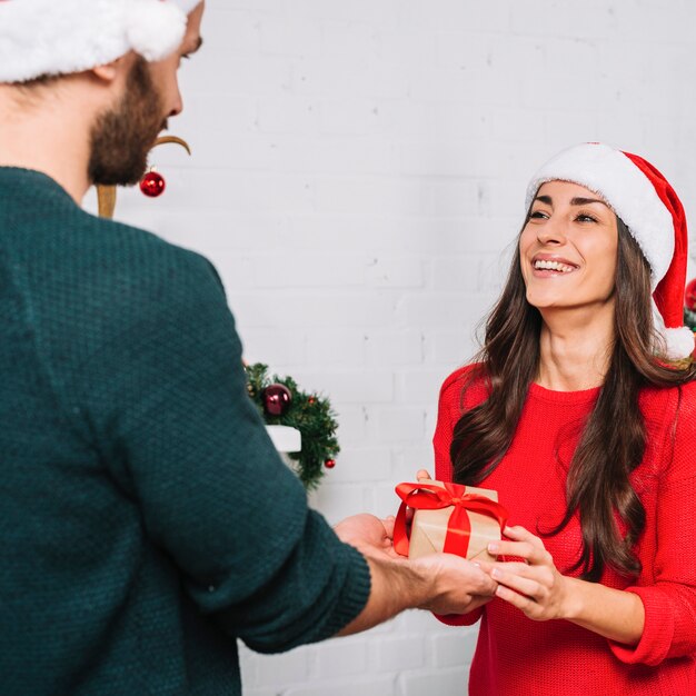 Hombre presentando regalo para mujer feliz