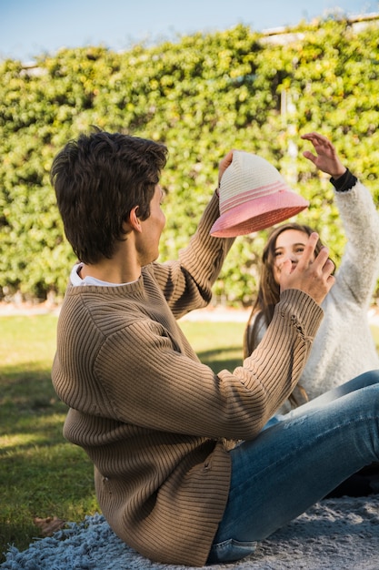 Hombre que sostiene el sombrero que se burla de su hija