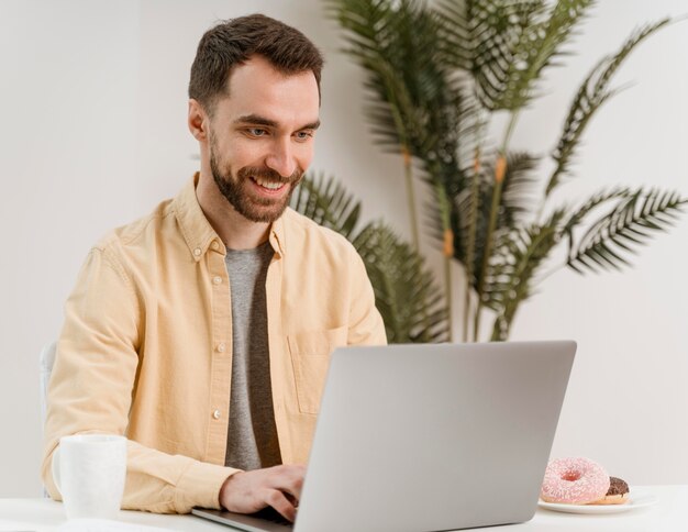 Hombre que tiene videollamada en la computadora portátil