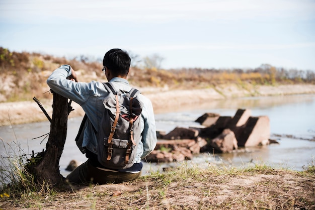 Hombre relajante cerca del lago