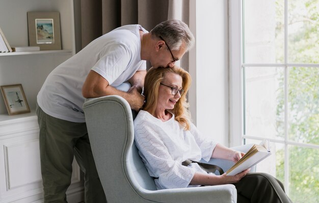 Hombre senior encantador besando a mujer