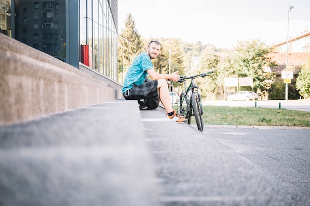 Hombre sentado con bicicleta