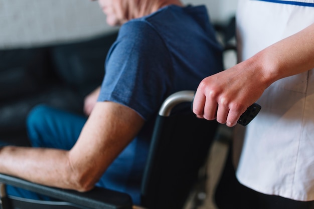 Hombre en silla de ruedas en asilo de ancianos