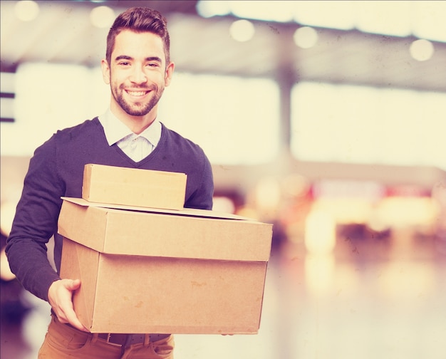 Foto gratuita hombre sonriendo sujetando cajas de cartón