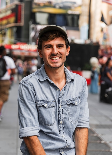 Hombre sonriente en la ciudad mirando a cámara