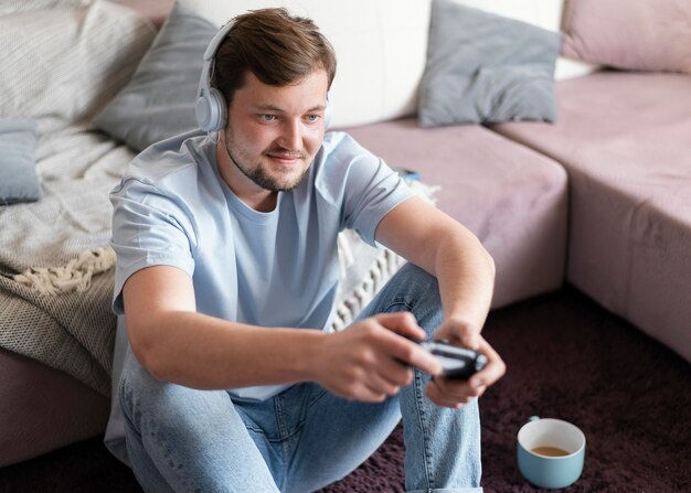 Hombre sonriente con controlador de tiro medio