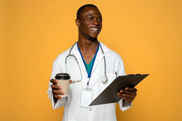 Foto gratuita hombre sonriente sosteniendo una taza de café de tiro medio