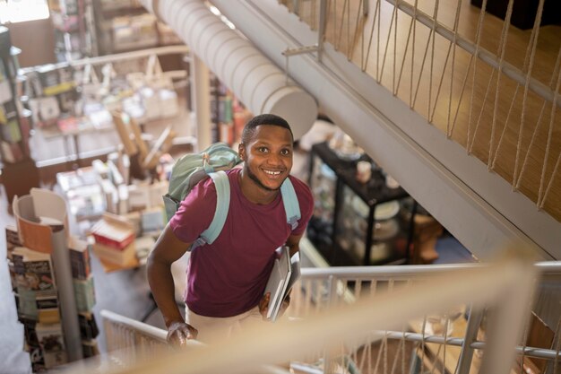 Hombre sonriente de tiro medio con libros