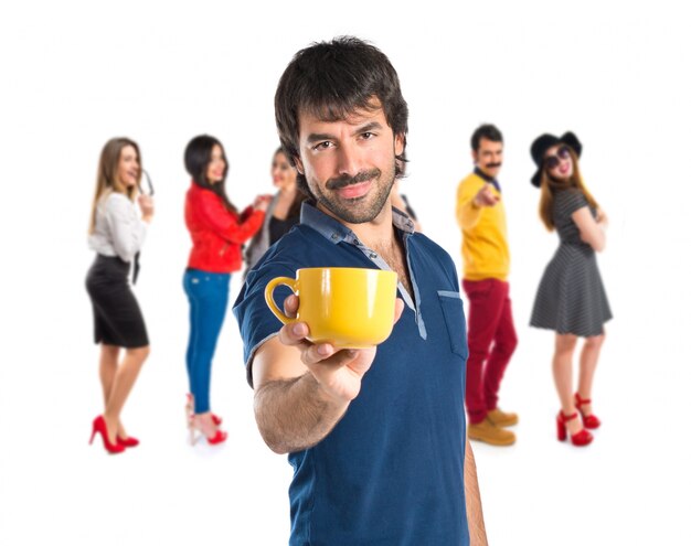 Hombre sosteniendo una taza de café sobre fondo blanco