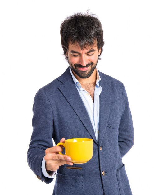 Hombre sosteniendo una taza de café sobre fondo blanco