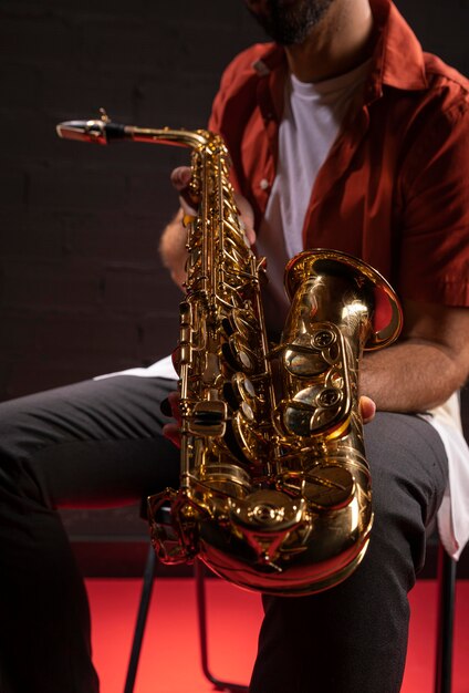 Hombre sujetando un saxofón