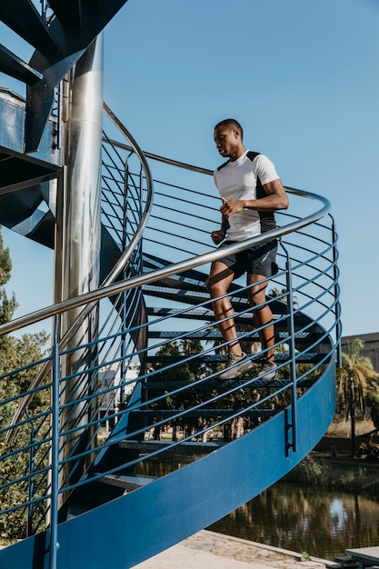 Hombre de tiro completo corriendo en las escaleras